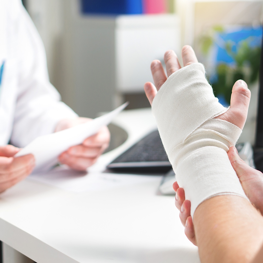 injured wrist and a doctor discussing treatment