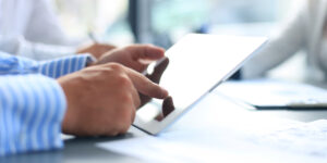 man working on a ipad and searching for a lawyer