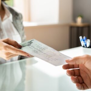 person being handed a check